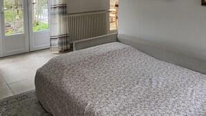 A bedroom with a bed, a ceiling light fixture, a window with curtains, and a view of the outside. - Family home in the heart of the Eure valley - 10 people - 5 bedrooms (Breuilpont)