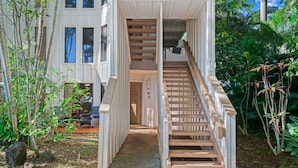 A wooden staircase leading to a building with a white exterior and multiple windows. - Waikomo Stream Villas 100 | Tropical Poipu Retreat Near Beach (Koloa)