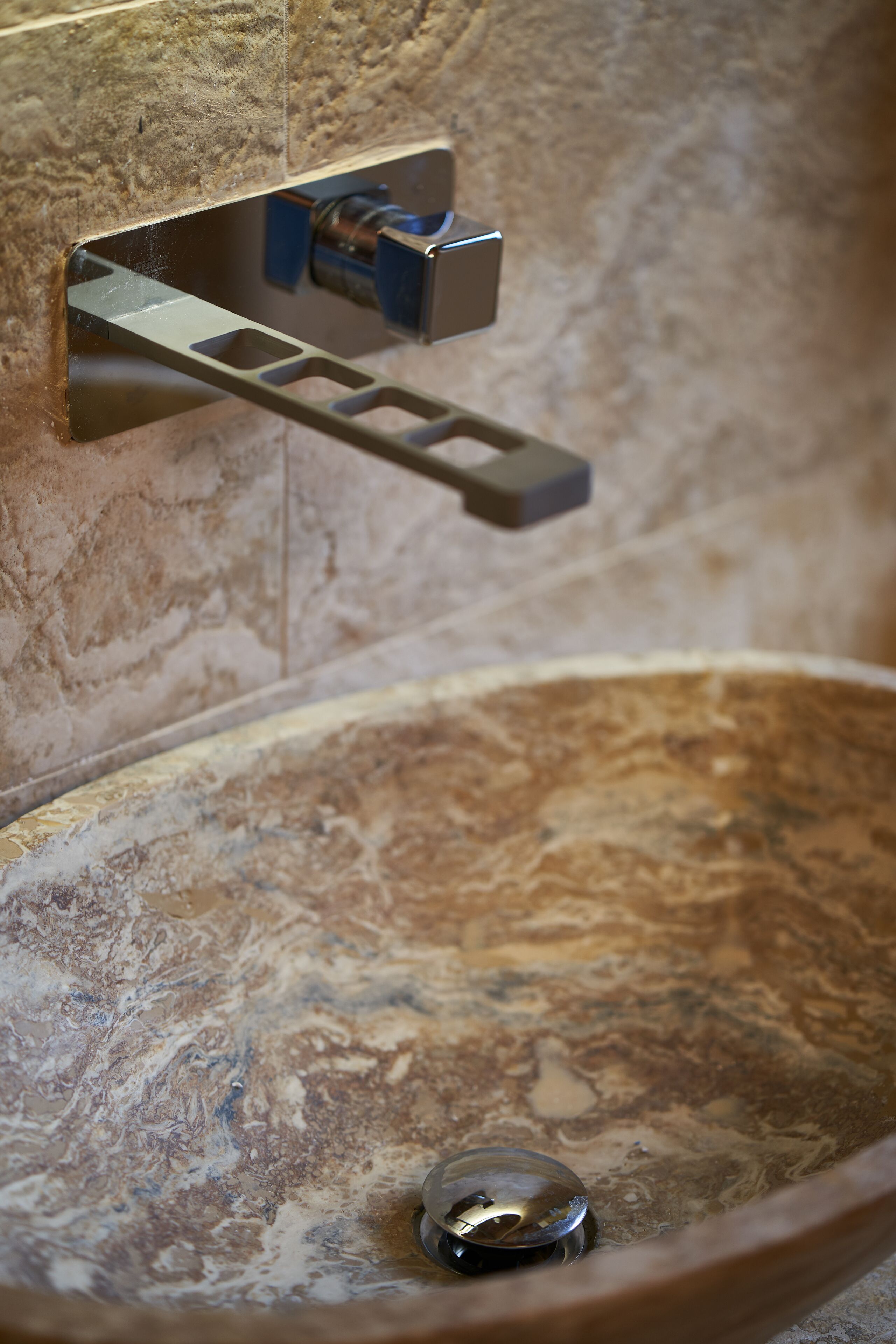 A bathroom with a marble sink and a towel rack.