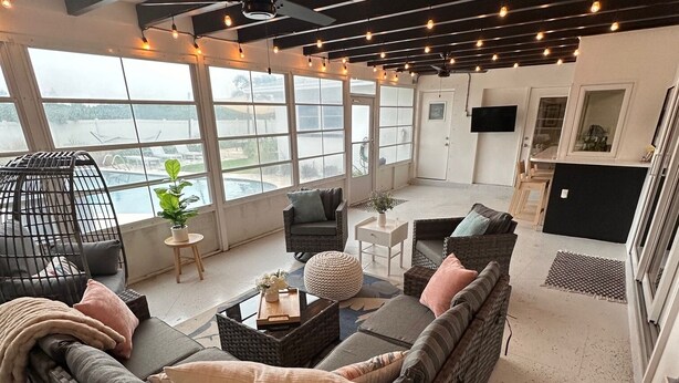 A spacious living area with a large sectional sofa, a ceiling fan, and a view of the outdoors. - 4 BR, 5 Bed, 2 King, 2 Bath, Private Pool (Cocoa Beach)