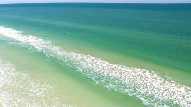 A beach with clear water and a sandy shore. - St Augustine waterfront home on canal w/ private dock, walk to beach! (St. Augustine)