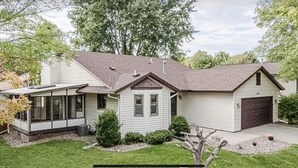 A single-story house with a garage, a small attached garage, and a covered porch. - Home Calls the Heart- 10 minutes to Mayo.  Split-level home with fenced-in yard. (Rochester)