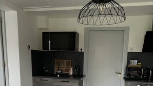 A modern kitchen with a dining area.