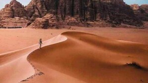 A desert landscape with sand dunes and rocky formations. - Abdullah Ram  (Wadi Rum)