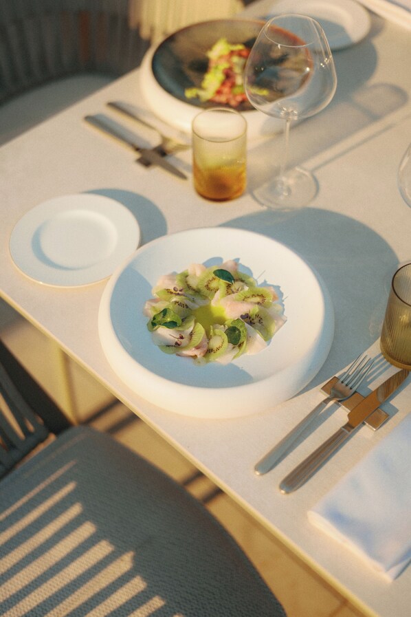 A table set with plates, cutlery, and a glass of water. - Bellerive Lifestyle Hotel (Salò)