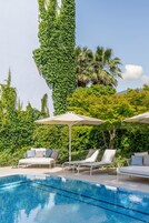 Seasonal outdoor pool, open 9:00 AM to 5:00 PM, pool umbrellas