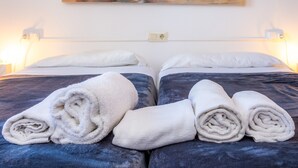 A double bed with white linens and a painting of a boat on the wall. - Holiday Apartment "Mhm 3" with Balcony & Wi-Fi (Cala Ratjada)