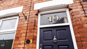 A dark blue door with the number 19, a brass knocker, and a small brass plate with the number 10. - Alices Central Stay Parking  Motor Point Arena (Sneinton)