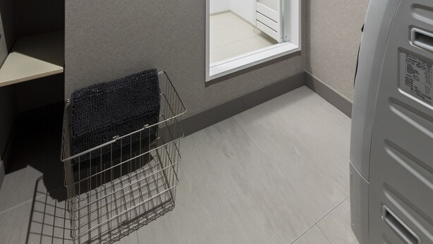 A corner of a room with a built-in bench, a window, and a wall-mounted heater.