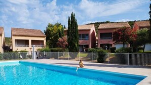 A swimming pool with a person sitting by the edge. - Casarella Massari (Oletta)