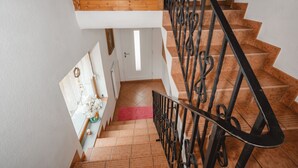 Eine Treppe mit hölzernen Stufen und schwarzen Metallgeländern.