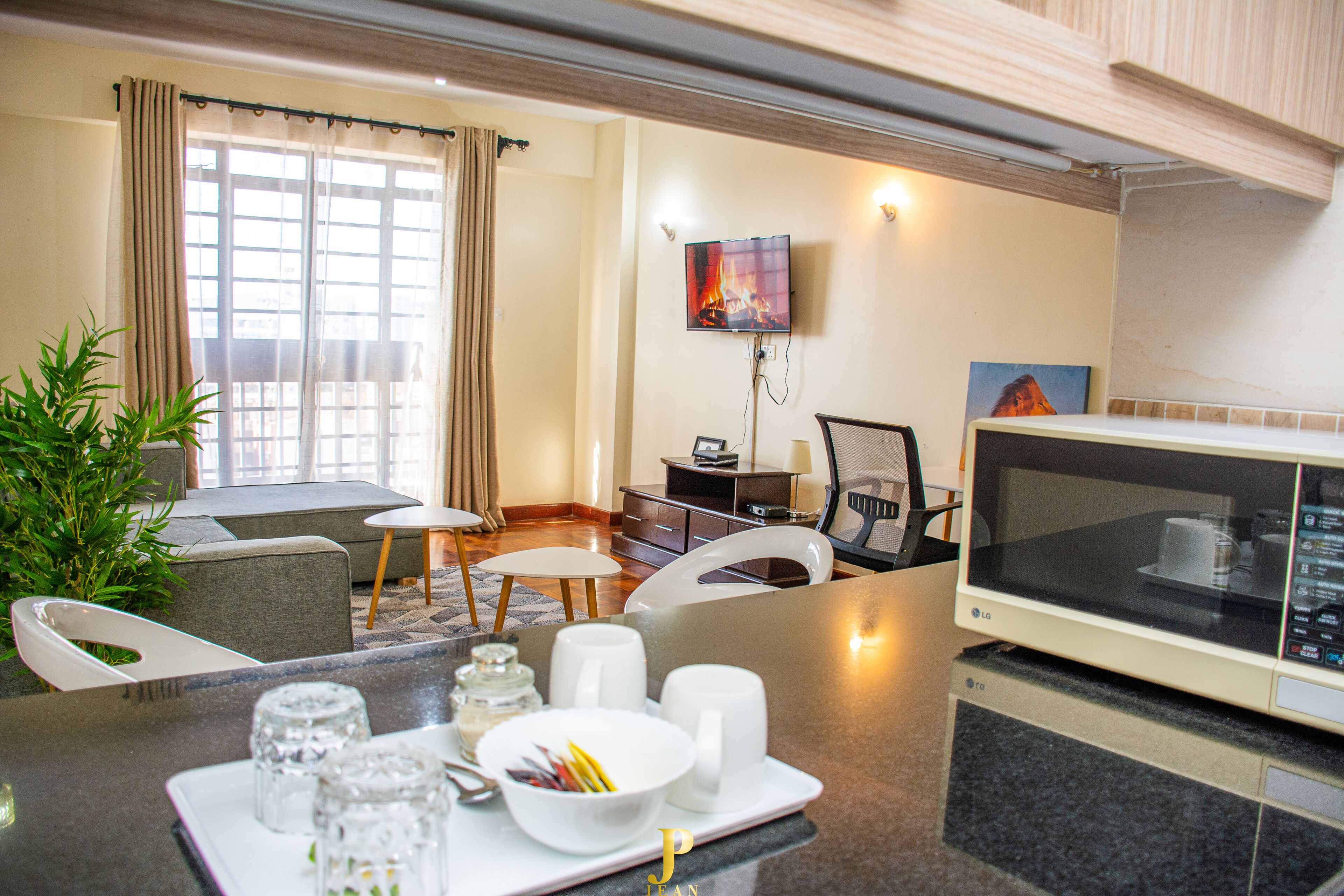 Business Apartment | Living area | 24-inch Smart TV with satellite channels