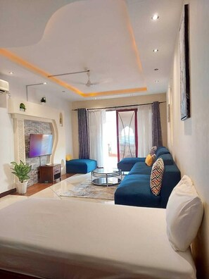 Deluxe Apartment | Living area | 24-inch Smart TV with digital channels - Lux Suites Shanzu Seabreeze Apartments (Mombasa)