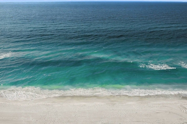 A beach with clear turquoise water and a sandy shore. - Brand New Everything! Private Beach & 3 Htd Pools! (Siesta Key)