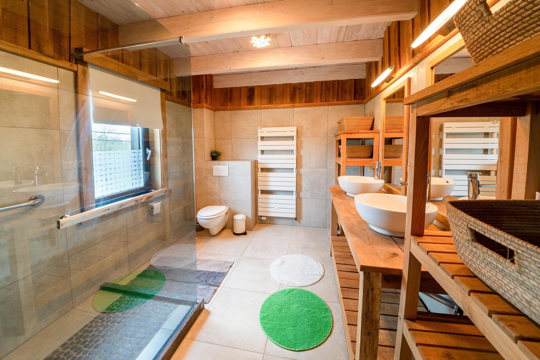 A modern bathroom with a glass shower enclosure, a toilet, a sink, and wooden shelves.