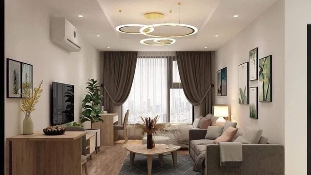 A modern living room with a sofa, coffee table, and artwork on the walls. - KHANG LINK (Bai Chay)