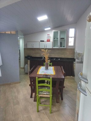 Enjoy meals in this cozy dining area with a wooden table and matching chairs.