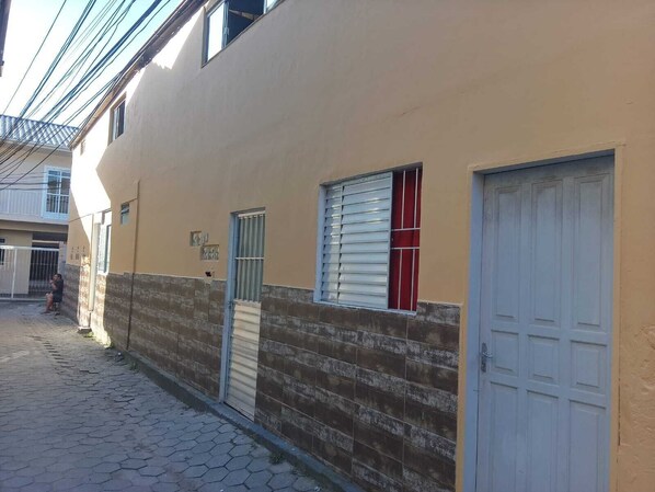 Stroll through a quiet, narrow alleyway lined with buildings.