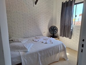 Relax in this serene space with a comfortable bed and a large window offering a view.