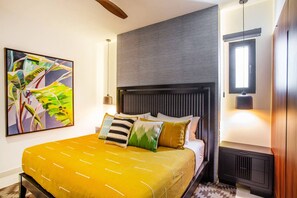 The master bedroom features a comfortable king-size bed, ensuite bathroom and smart TV - Modern Luxury 2BR in Romantic Zone (Puerto Vallarta)