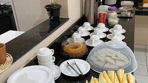 A buffet setup with various food items and serving utensils. - Hostel da Fonte (São Luís)
