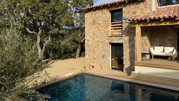 A stone villa with a swimming pool, a wooden deck, and a view of the surrounding trees. - Maison de Type Bergerie , Proximité Porto Vecchio - Www.casarella.eu (Zonza)