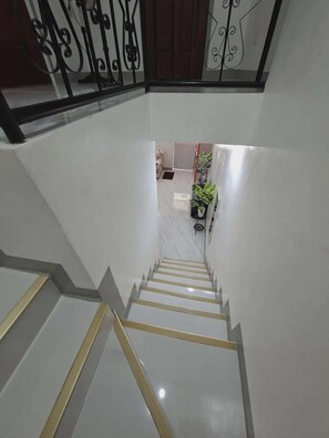 A staircase with a handrail and a railing with decorative elements. - Beautiful Compostela 2 Story Townhouse with Patio  (Compostela)