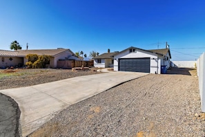 A residential area with houses, a driveway, and a clear sky.