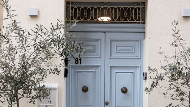 A double door with the number 81, a small balcony with a metal railing, and two potted olive trees on either side. - Concetta Studio Apartments  (Cospicua)