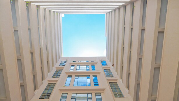 A high-rise building with a central atrium and multiple floors. - Quiet Urban Stay with Views, 0742 for 616 then 120 (Nairobi)