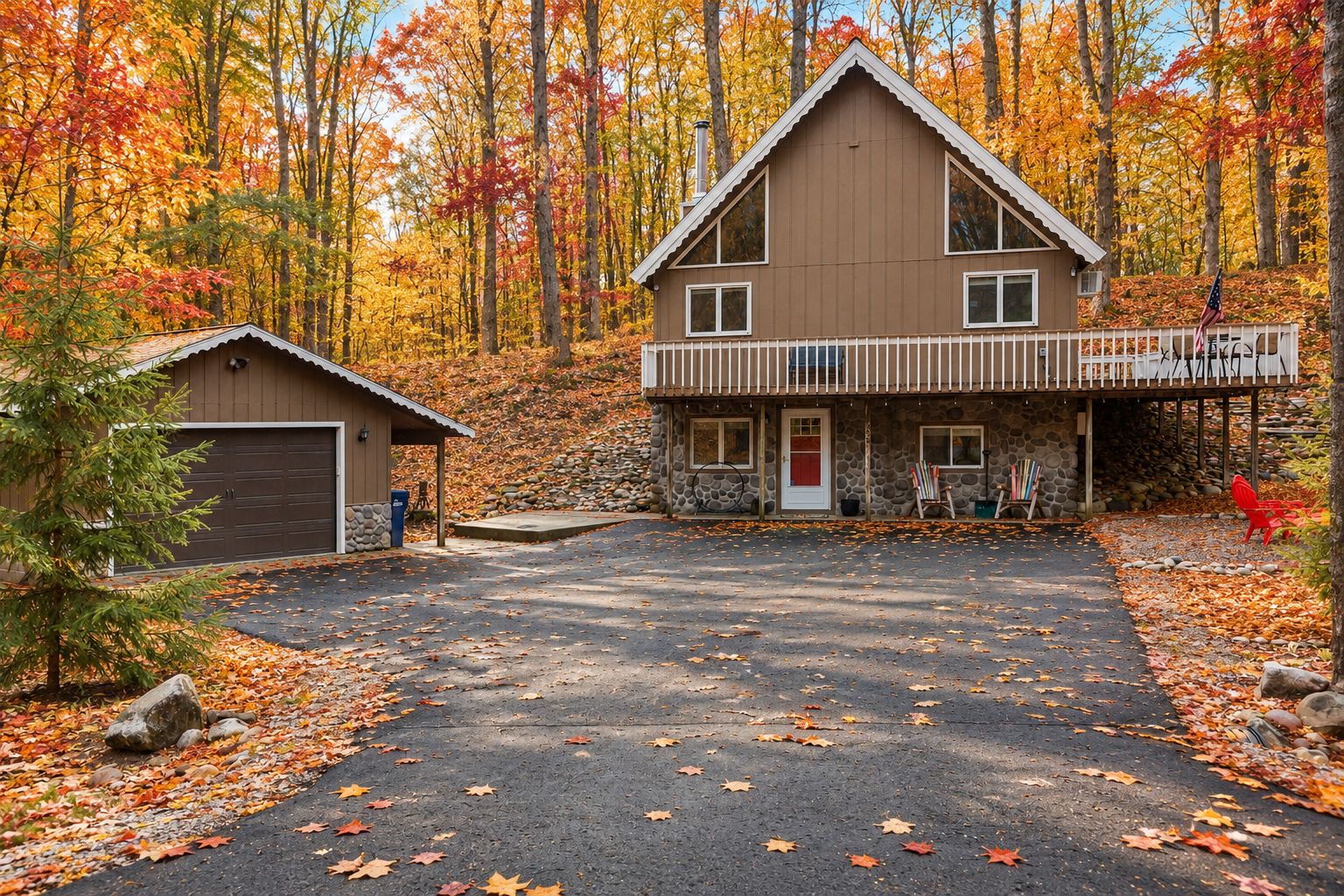 A two-story house with a garage, a covered porch, and a stone wall.