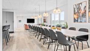 A modern conference room with a long table, black chairs, and pendant lights. - Pet friendly home in Løgstrup with sauna (Løgstrup)