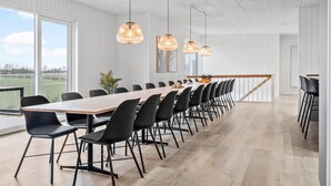 A spacious conference room with a long table, black chairs, and pendant lighting. - Pet friendly home in Løgstrup with sauna (Løgstrup)
