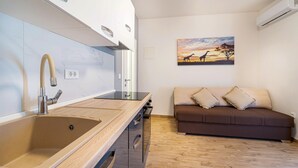 Eine moderne Küche mit Spüle, Herd und einem Giraffenbild an der Wand.