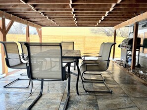 An outdoor patio with a wooden pergola, a table, chairs, and a barbecue grill. - Spotless, Family-Friendly Gem! Hot Tub, Steam Shower, Playground & Gym (Lafayette)