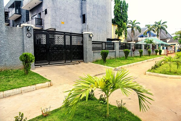 Stunning residential building with a modern design, surrounded by lush greenery and a quiet neighborhood.