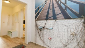 An art gallery with a large painting of a pier. - Eickhus Weisse Wohnung by Interhome (Zinnowitz)