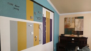 A living room with a wall clock, a desk, a chair, and a sofa. - Charming 3 Bed 2 Bath Home in NE San Antonio (Converse)
