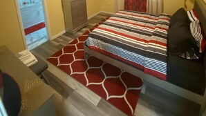 A bedroom with a bed, a dresser, a TV, a ceiling fan, and a window with curtains. - Charming 3 Bed 2 Bath Home in NE San Antonio (Converse)