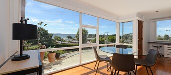 Panoramic water views, sunny and private - walk to beach, cafes and shops