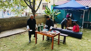 An outdoor setting with a table, benches, and a tent. - Hotel Thimphu Central (Thimphu)