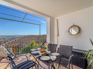 Enjoy a romantic meal for two on this balcony with a stunning view of the surrounding landscape.