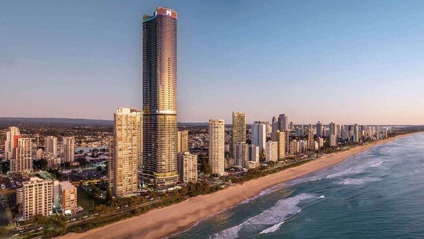 A coastal cityscape with high-rise buildings, a beach, and a clear sky. - Luxe Oceanfront 1-Bed High Rise with Pool & Gym (Surfers Paradise)