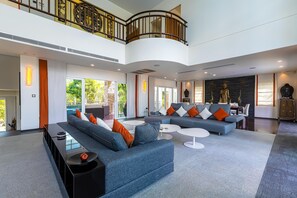 Exclusive Villa | Living area | 65-inch TV with cable channels