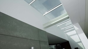 A modern interior with a sloped ceiling, skylights, and a concrete wall. - Atlantic House - Marina (Ponta Delgada)