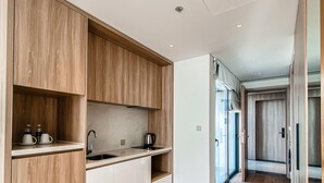 A modern kitchen with wooden cabinetry, a built-in sink, and a countertop.