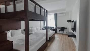 A modern bedroom with a bunk bed, a desk, and a television.