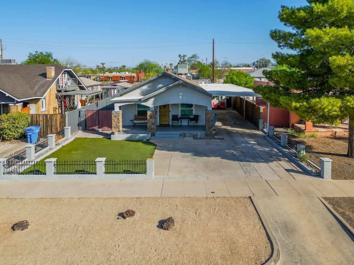 A residential property with a paved driveway, a front lawn, and a garage.