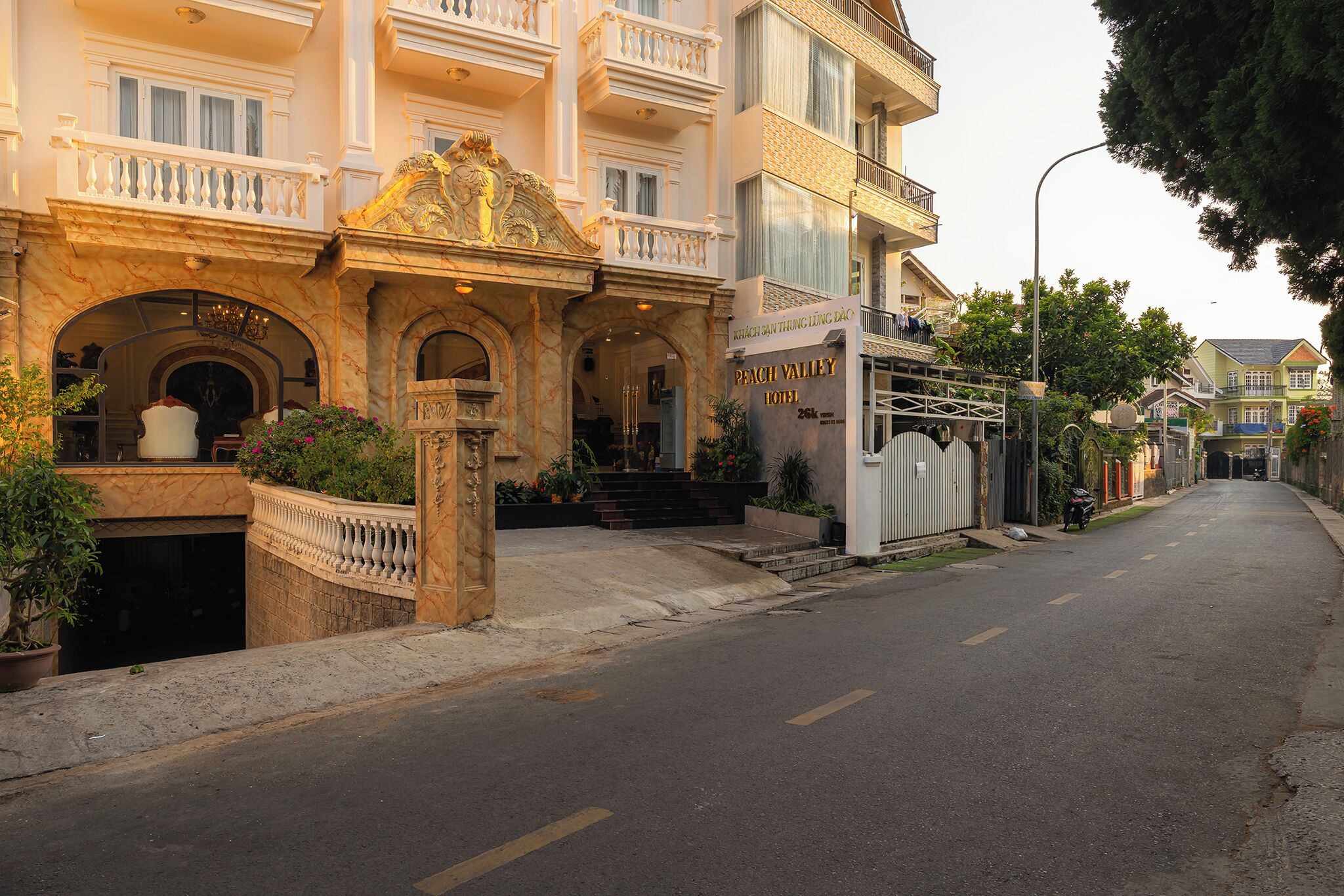 A hotel with a grand entrance, a sign indicating 'PENCH VALLEY HOTEL,' and a staircase leading to the entrance.