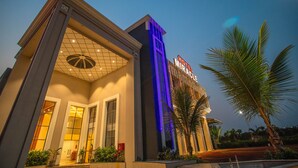 A hotel with a modern facade, large glass windows, and a prominent sign. - Hotel Miracle  (Ujjain)